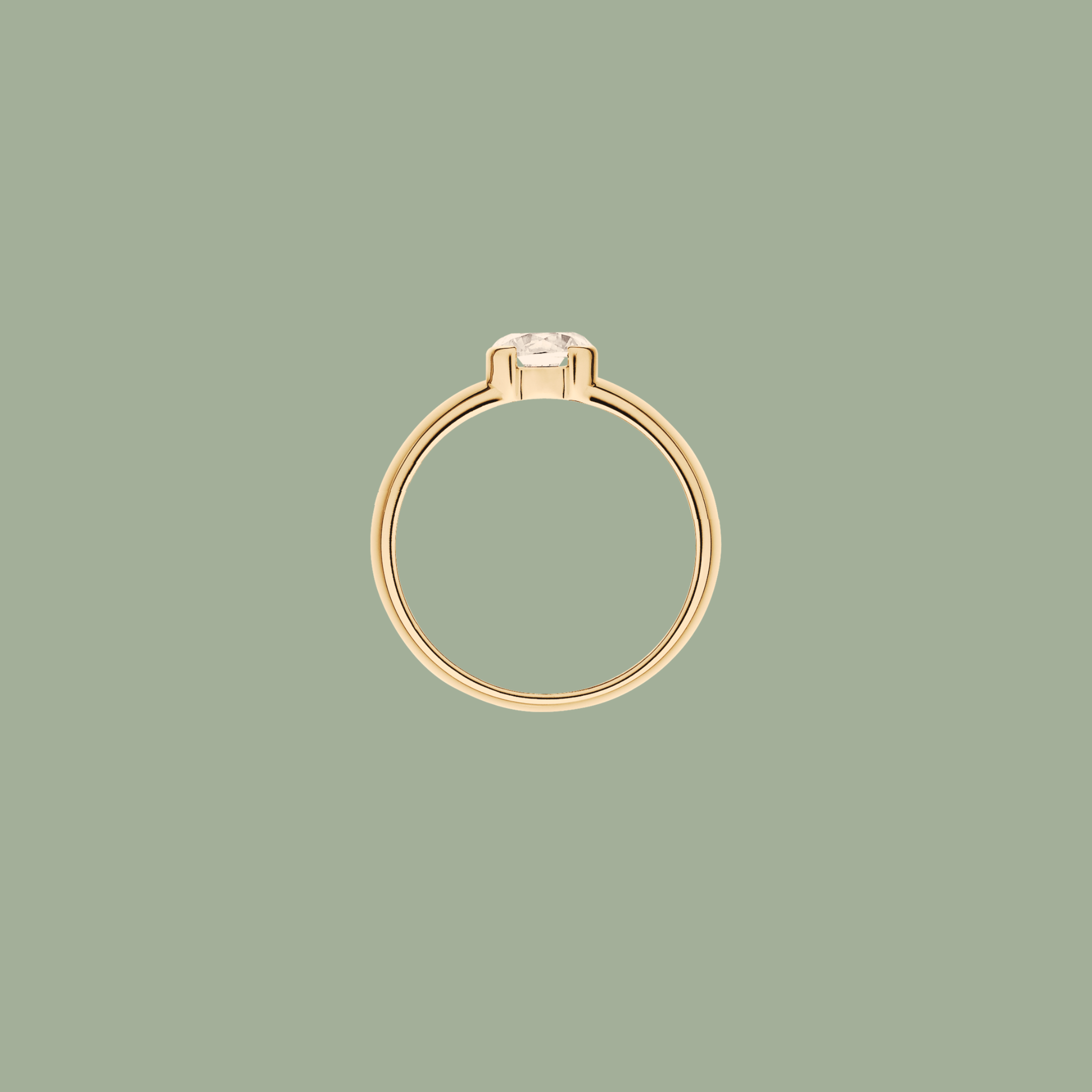 Classic gold ring with a diamond, set against a soft green background