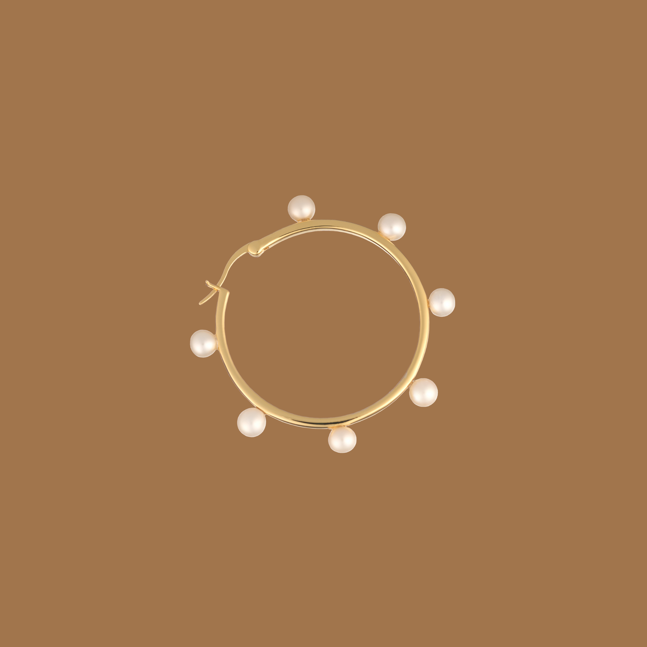 Elegant gold hoop earring adorned with pearls on a beige background
