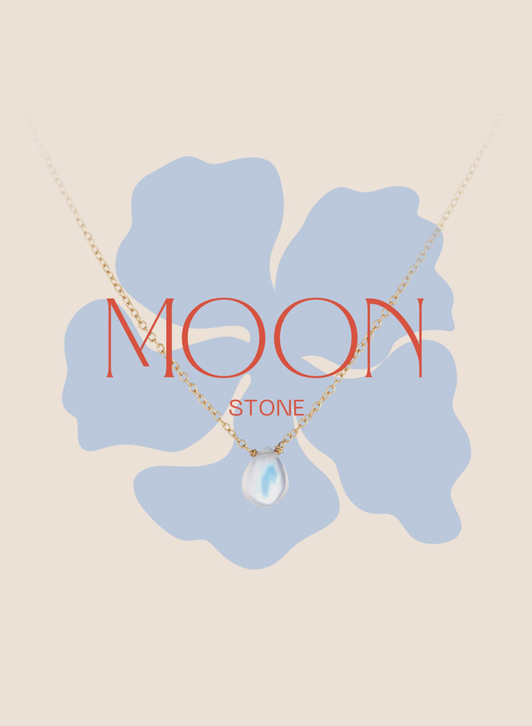 Gold necklace with moonstone pendant on floral background