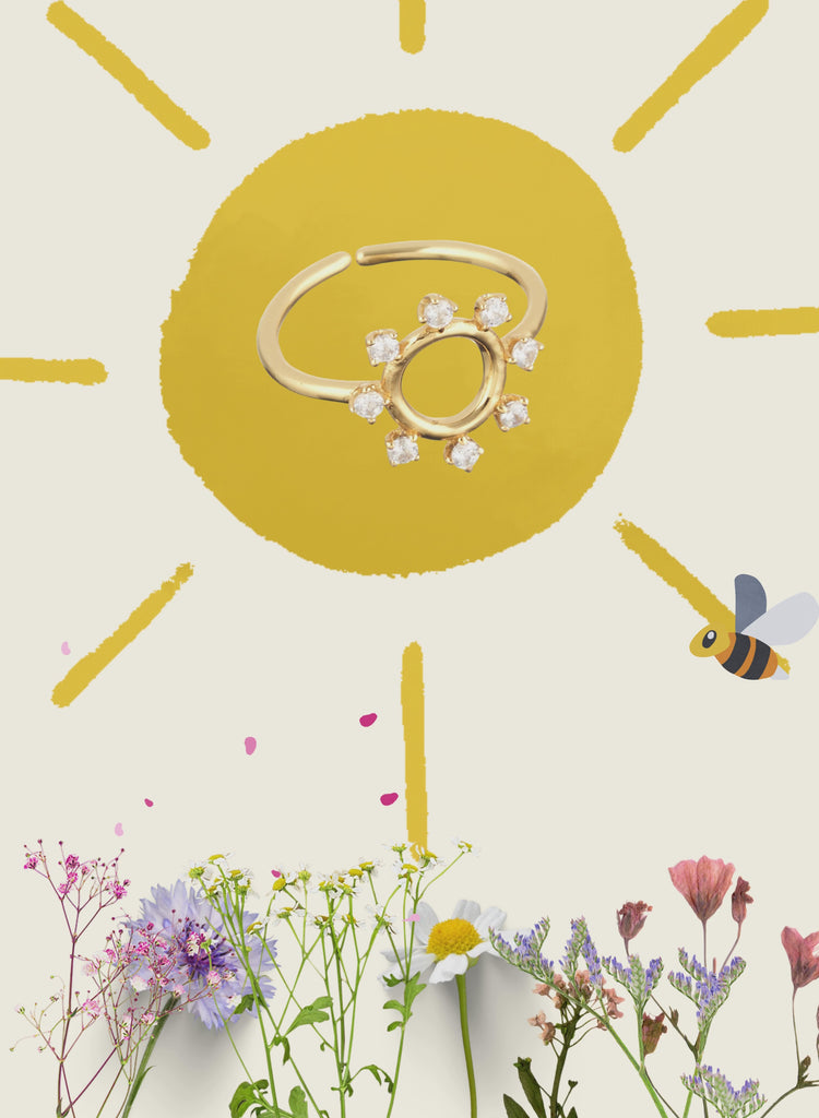 Gold ring with diamonds on a sun-themed background